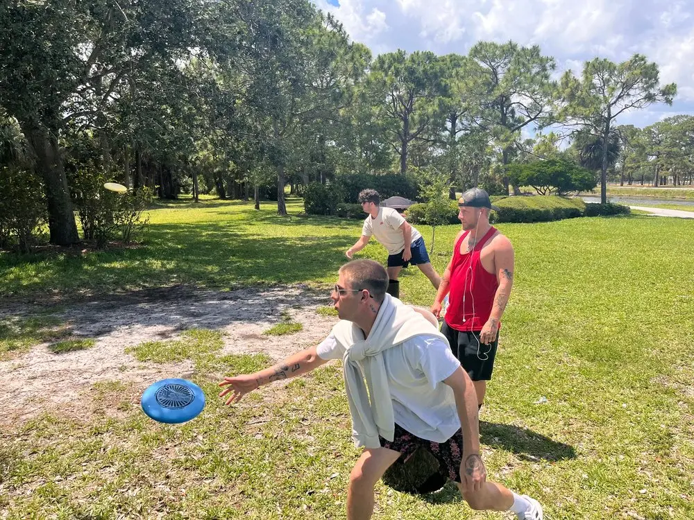 alumni playing frisbee golf