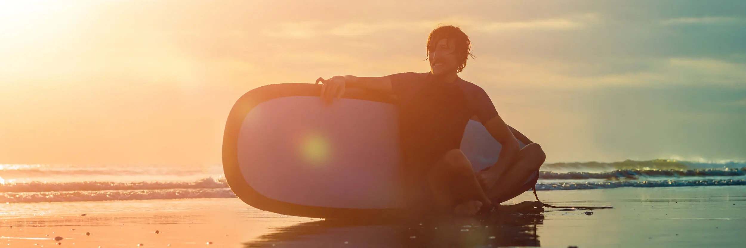 a man sitting on a surfboard