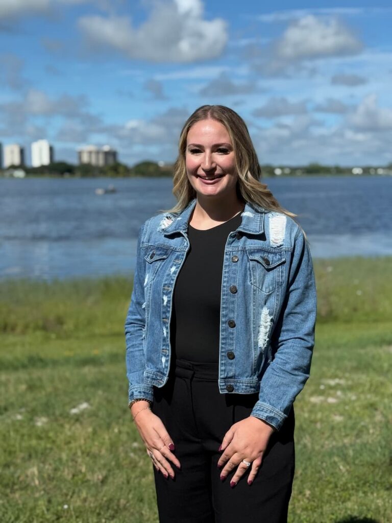 Portrait of a woman standing outdoors by the water